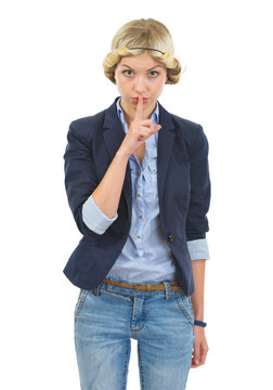 Teenage girl showing shh gesture