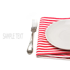 Empty white plate on tablecloth with fork on white background