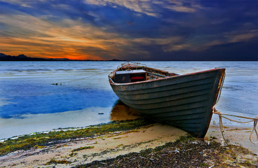 Old fishing boat at colorful sunset