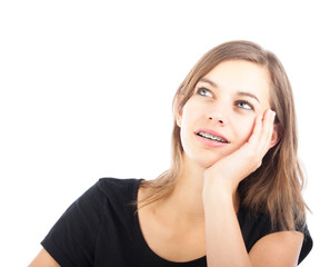 Fototapeta premium A young pensive girl looking up