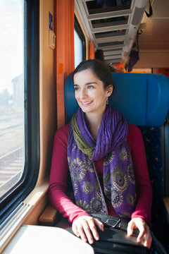 Portrait of a young woman traveling by train