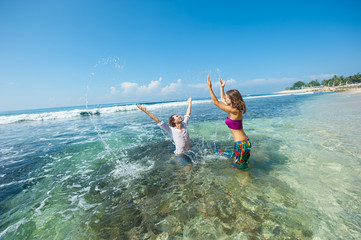 loving couple resting on the beach in the sand on the island of Bali.