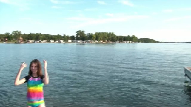 Girl Waves In Lake to Swim