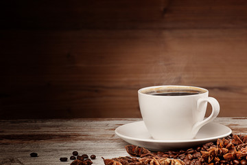 white cup of coffee over wooden background