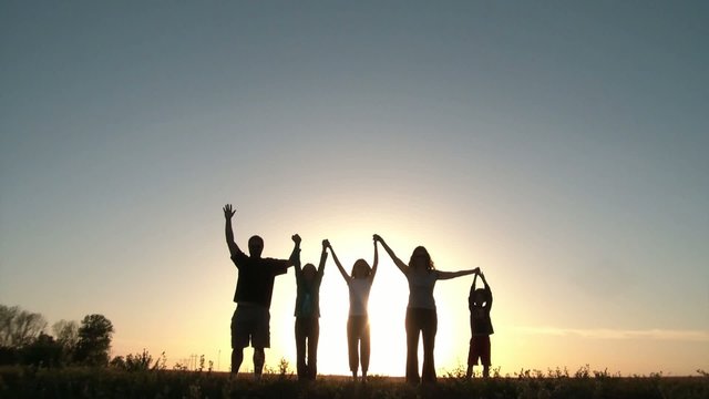 People Raising Arms Together at Sunset