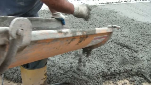Wet Cement Flowing from Chute on Truck