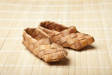 bast, ancient russian shoes on wooden floor