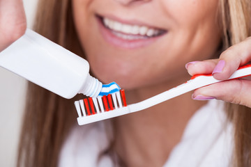 Mom put toothpaste on toothbrush