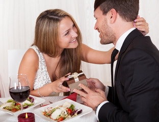 Young woman gives a gift