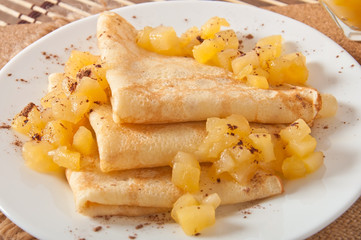 Sweet crepes with apple caramel and cream 