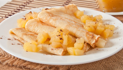 Sweet crepes with apple caramel and cream 