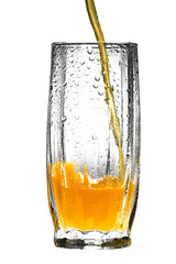 orange juice pouring into glass on white background