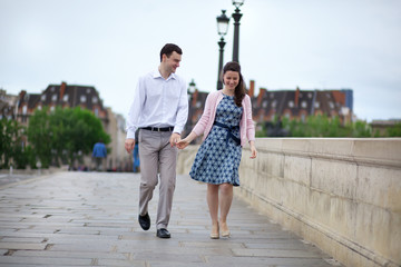 Fototapeta premium Dating couple in Paris walking hand in hand