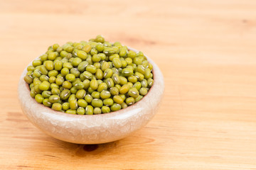 Green mung beans in bowl on white background
