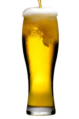 Beer is pouring into glass on white background