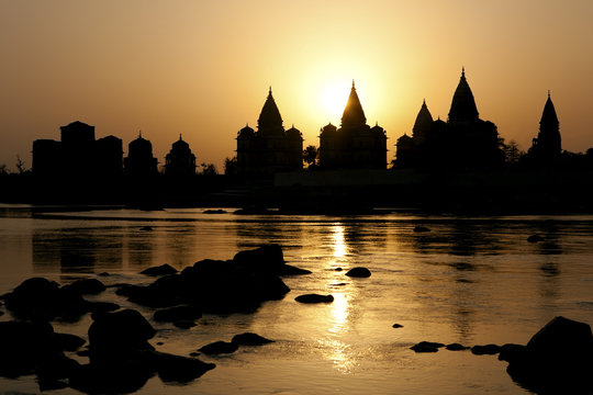 Sunset silhouette of Chhatris by the river in Orchha