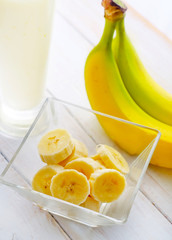 Fresh banana in the glass bowl, banana and milk