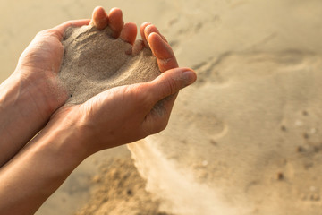 Sand through his fingers