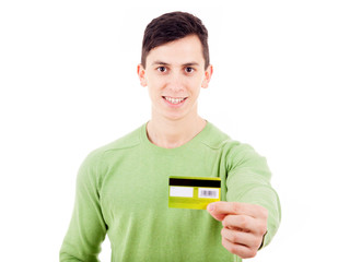 Young casual man with credit card on white background