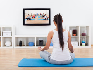 Spiritual woman meditating at home