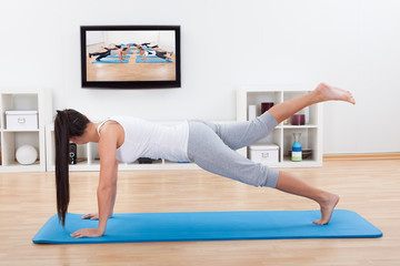Woman practicing yoga at home