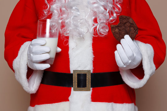 Santa Claus Holding Milk And Cookies