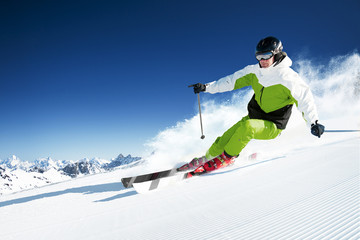 Skier in mountains, prepared piste and sunny day - obrazy, fototapety, plakaty