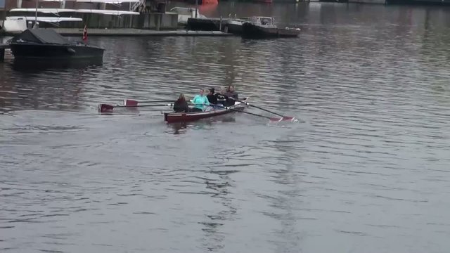 Sport boat rowing is on the canal in Amsterdam