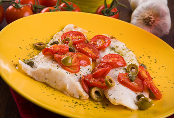 Fish with cherry tomatoes and olive.