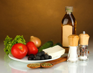 Ingredients for a Greek salad on brown background close-up