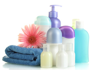 Obraz na płótnie Canvas kosmetyki butelki z ręcznikiem i kwiat samodzielnie na białym tle