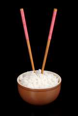 Bowl of rice and chopsticks isoalted on black