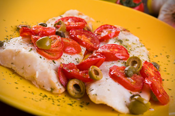 Fish with cherry tomatoes and olive.
