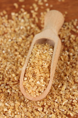 arnautka in wooden spoon on wooden background close-up