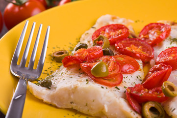 Fish with cherry tomatoes and olive.