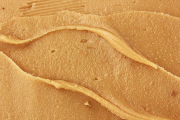 Delicious peanut butter close-up background