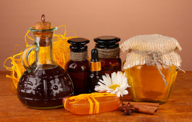 ingredients for soap making on brown background