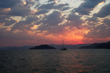 Fototapeta na wymiar Yacht in a sea on a background islands