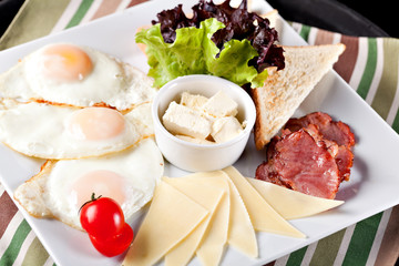 Breakfast fried eggs on a white plate