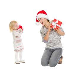 Happy mother and baby with Christmas present boxes