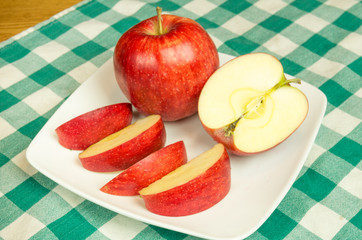 Jonagold apple slices on a white plate