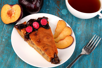 Tasty pie on plate on wooden table