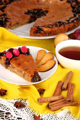Tasty pie on plate on wooden table