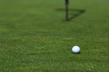 golf ball on lip of cup