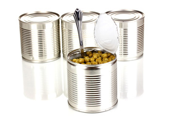 Open tin can of peas with spoon and closed cans isolated