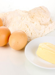 Eggs, flour and butter close-up isolated on white