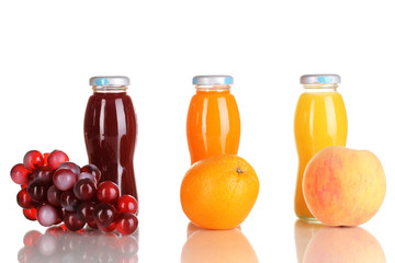 Delicious grapes, orange and apple juice in glass bottle and
