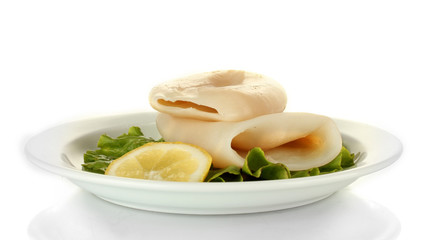 boiled squids with lettuce and lemon in the plate isolated