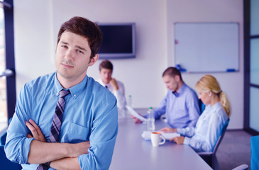 business man  on a meeting in offce with colleagues in backgroun