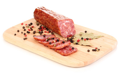 Tasty sausage on chopping board isolated on white